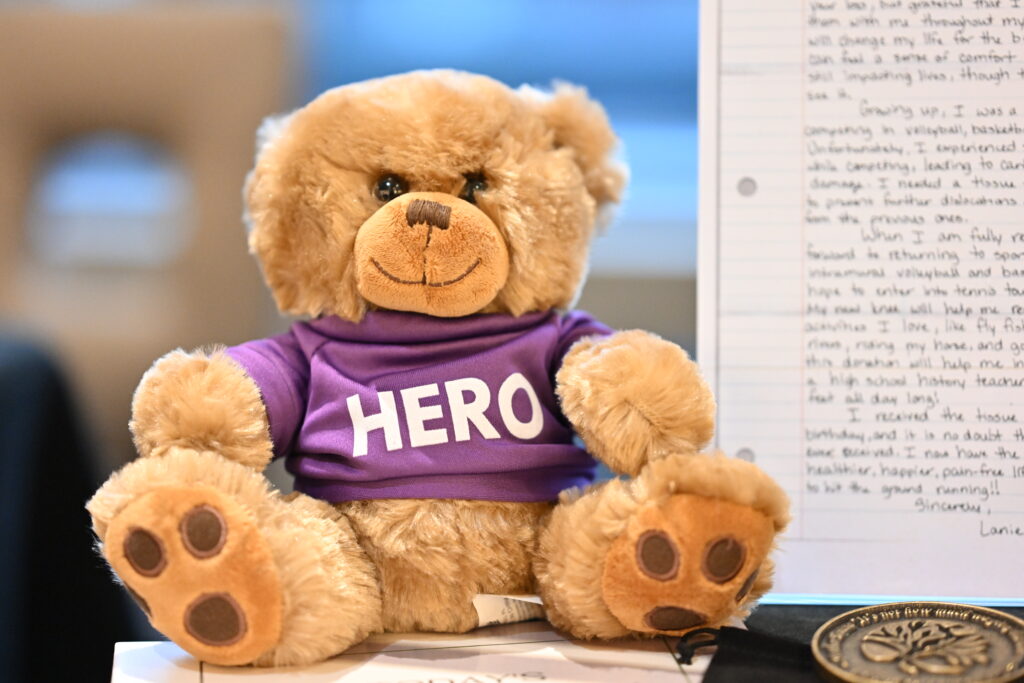 A hero heart bear at Infinite Legacy's Synergy Conference to show the power of donation.