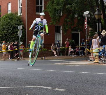 Bill Soloway, heart transplant recipient and proud member of The Wheelmen, races in Frederick to honor his donor James using a Donate Life high wheel bicycle.