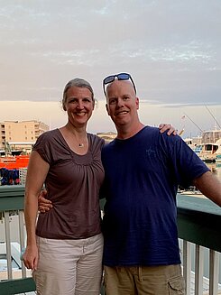 John Miller, a former Infinite Legacy employee awaiting a kidney transplant stands next to his wife.