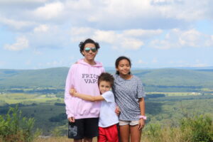 Dewey and his siblings with a scenic view in the background.