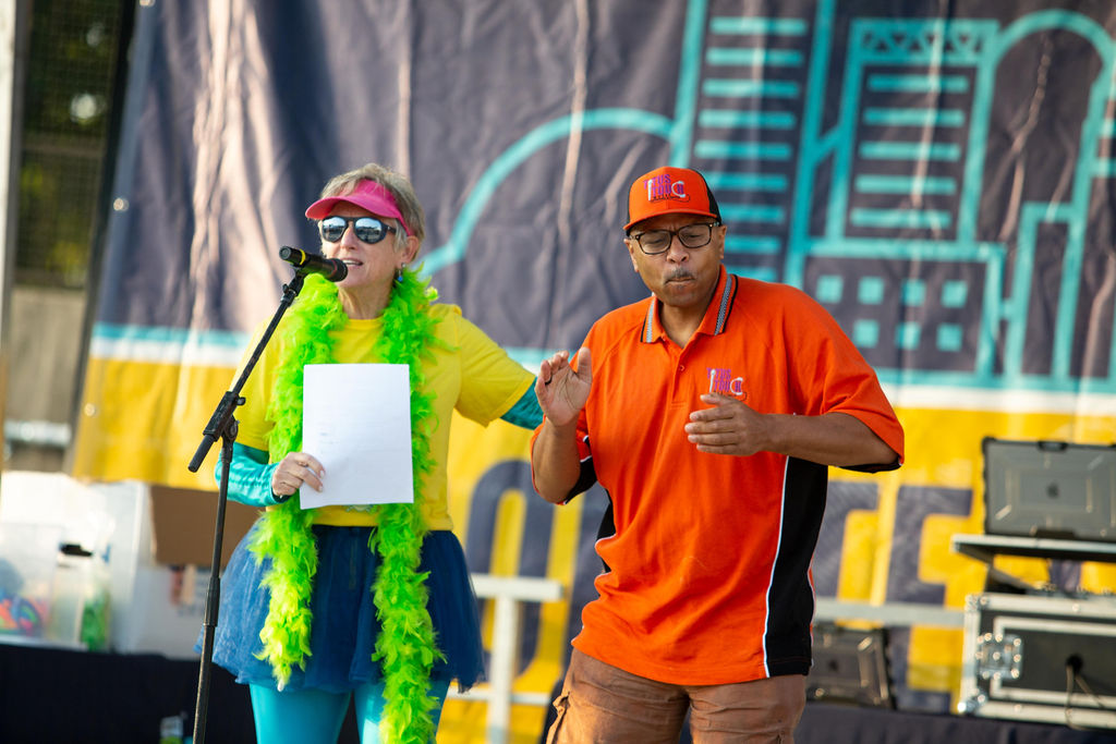 A man and woman present on stage at Infinite Legacy's Annual Donate Life Family Fun Run.