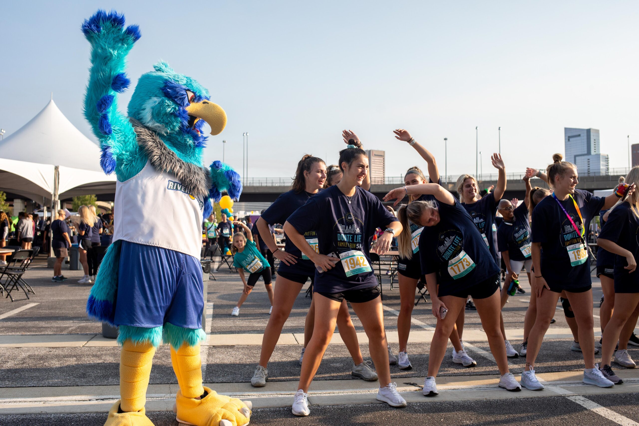 Teams participate in the warm up stretch at Infinite Legacy's Annual Donate Life Family Fun Run to honor organ, eye and tissue donors in Maryland, Northern Virginia and Washington, DC.