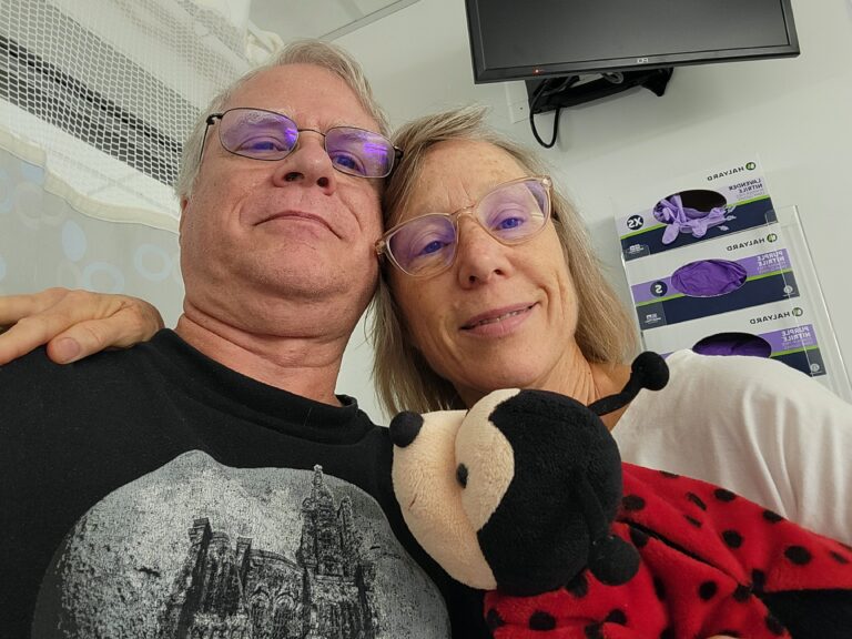 Susan and Ken hold Kimberly's ladybug stuffed animal as Susan prepares to donate one of her kidneys to save a life.