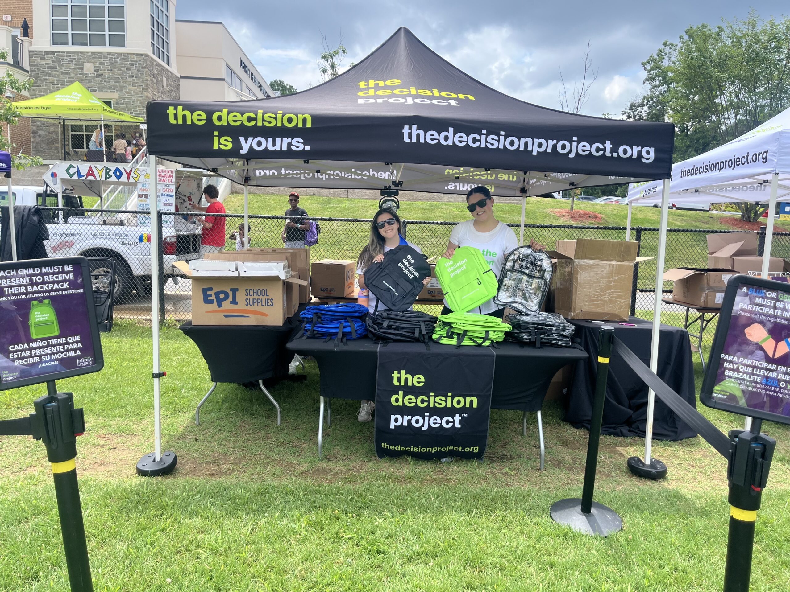 Two Infinite Legacy team members handing out The Decision Project backpacks at a Block Party in Maryland.